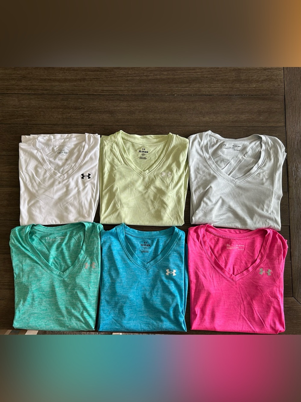 6 Women’s Under Armour tees